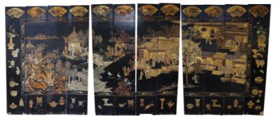 A tall Chinese coromandel lacquer twelve panel screen, 19th century, decorated with fan shaped