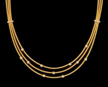 A modern Italian Marco Bicego 18ct gold and eleven stone diamond chip set triple strand necklace,