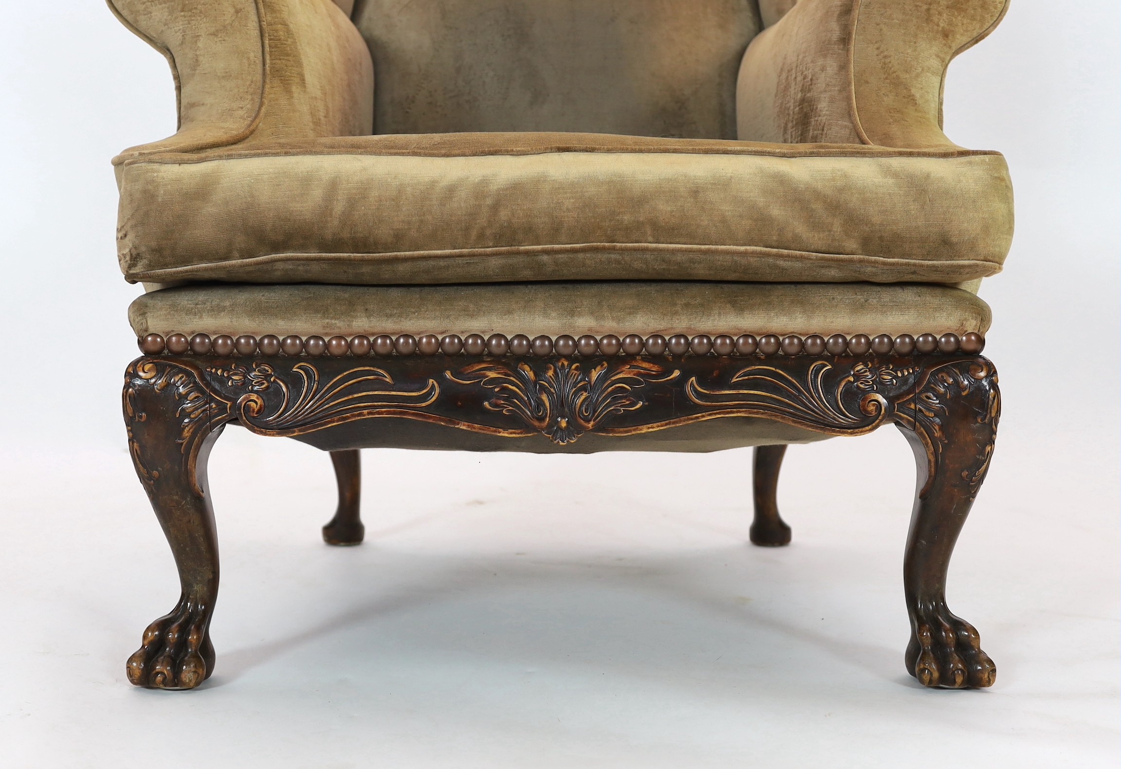 An Irish mahogany wing armchair, in George III style, with foliate scroll carved apron, on - Image 3 of 4