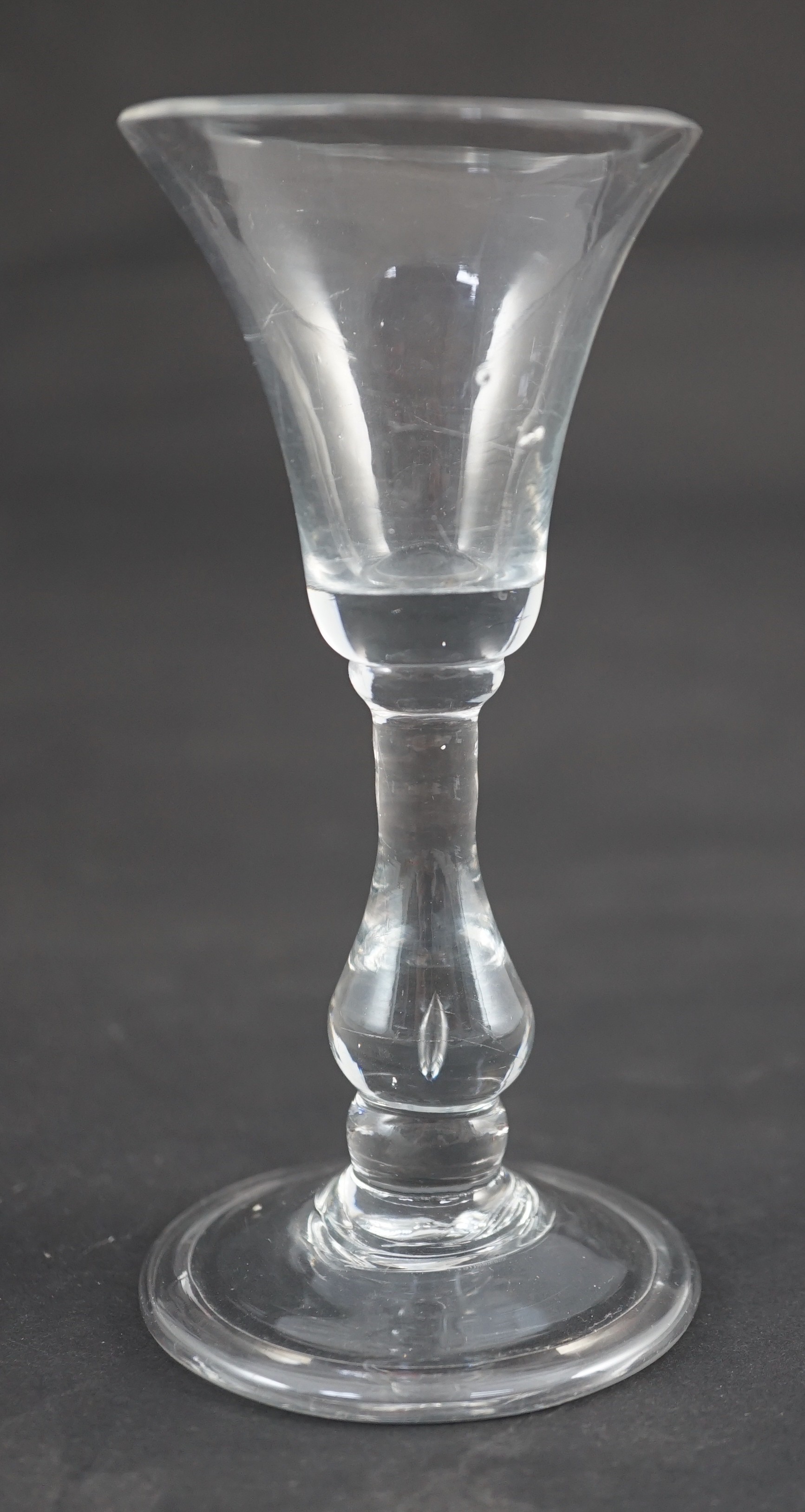 A true baluster wine or cordial glass, c.1720, the bell-shaped bowl above a tear drop baluster stem, - Image 3 of 5