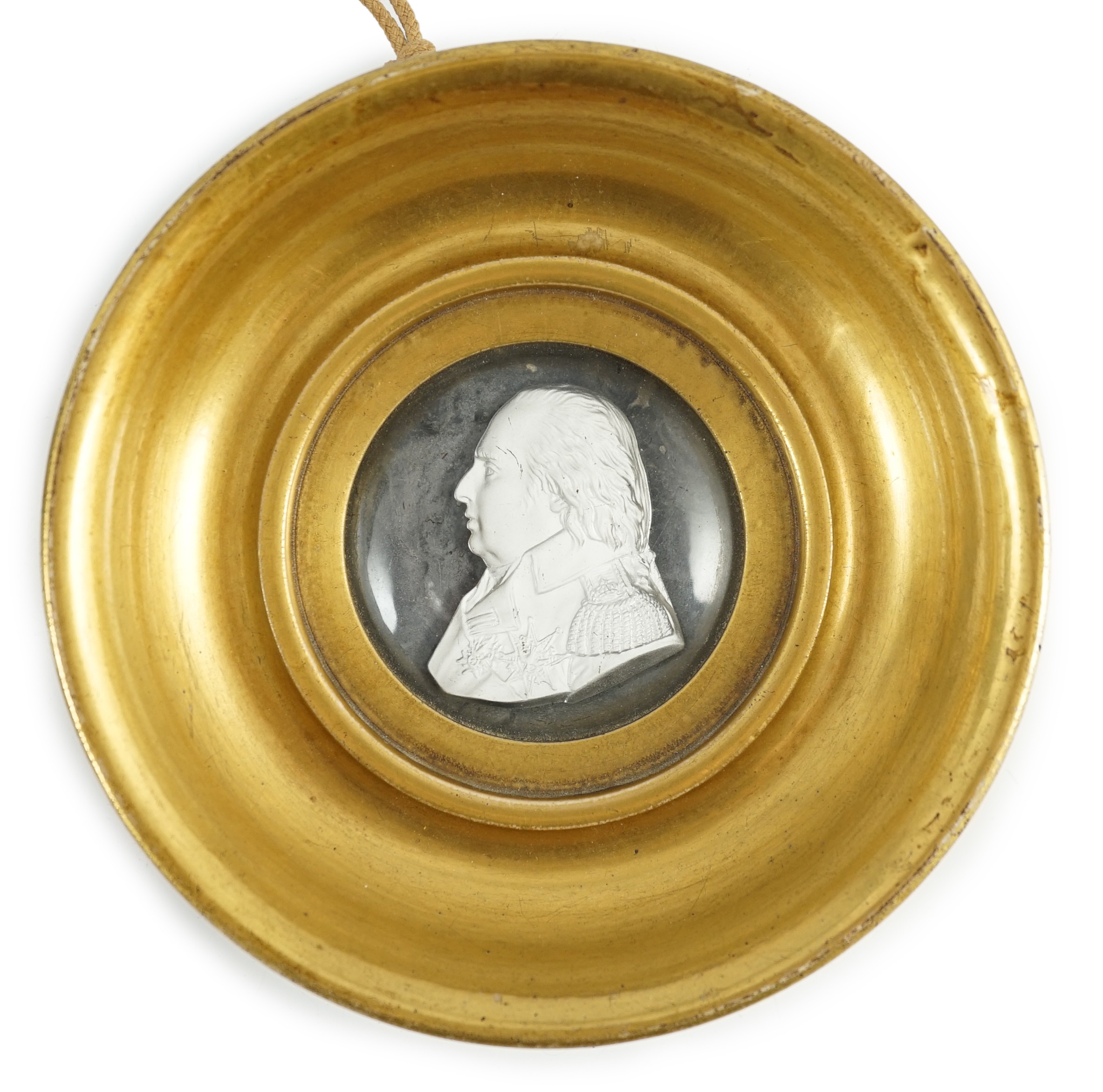 A Louis XVIII glass sulphide portrait plaque, in a gilded porcelain frame, c.1820, the cristallo-