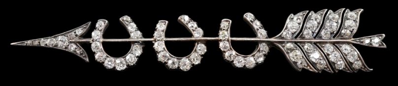 An Edwardian gold, silver and old round cut diamond set gold arrow and triple horseshoe motif set