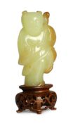 A rare Chinese yellow and russet jade figure of a boy holding a parrot, 18th/19th century,