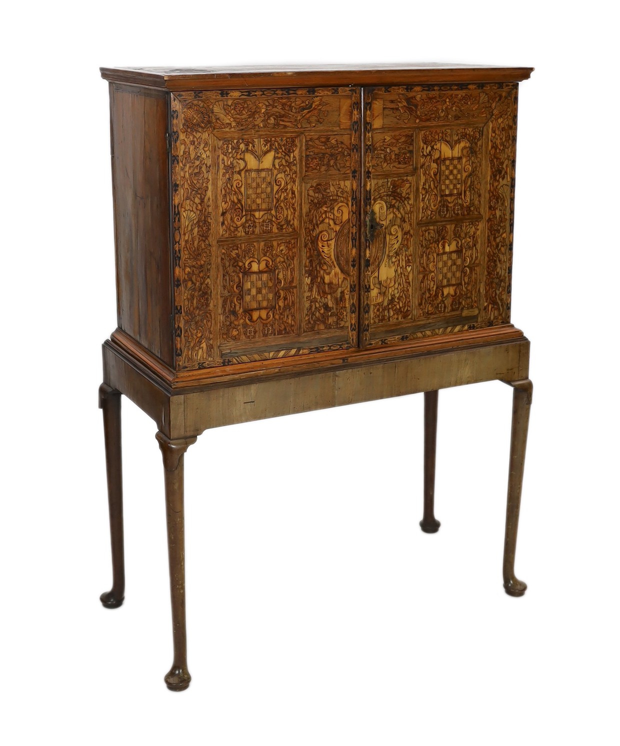 A 17th century and later South German walnut and marquetry cabinet on later stand, with moulded