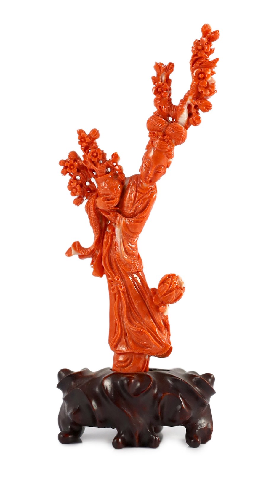 A Chinese carved coral figure of a flower fairy, 20th century, the figure holding a vase of