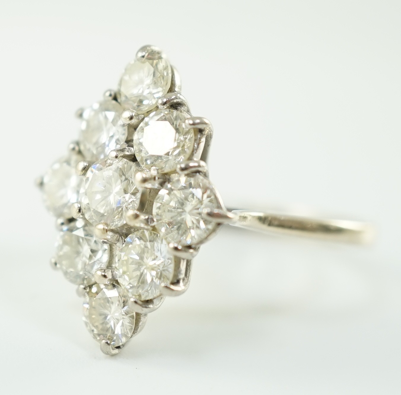 An 18ct white gold and nine stone diamond cluster set marquise shaped diamond ring, with a raised - Image 2 of 4