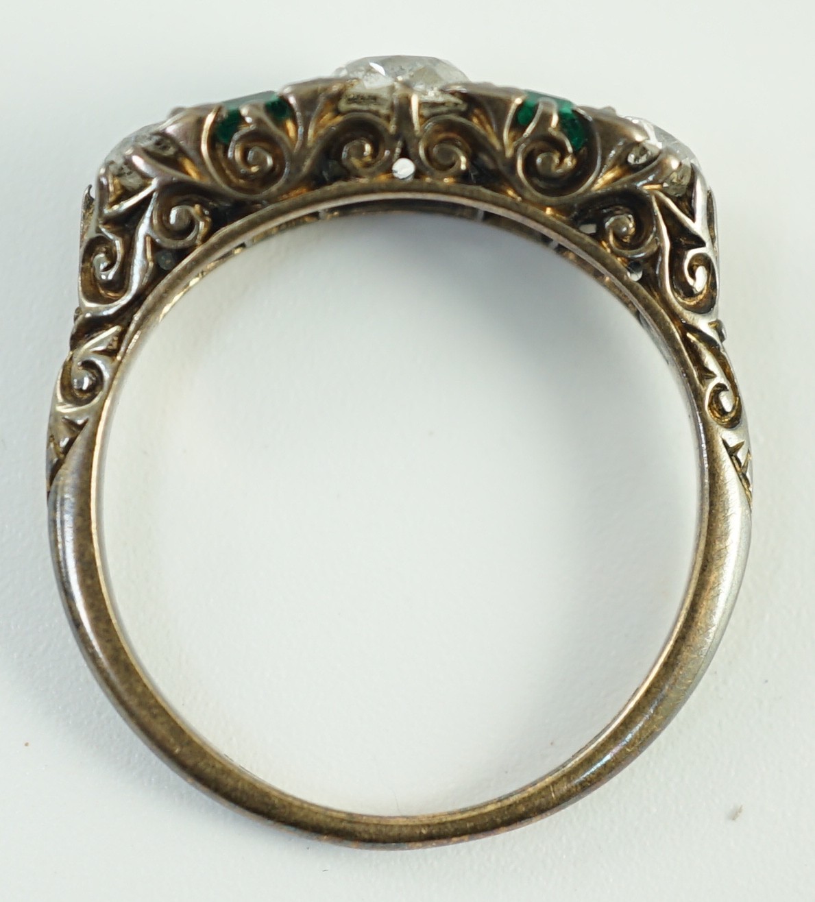 An early 20th century 18ct gold, three stone diamond and two stone emerald set half hoop ring, - Image 9 of 10