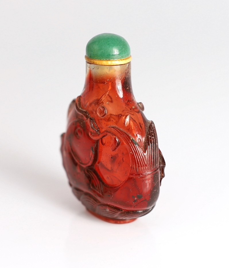 A Chinese ruby red glass ‘leaping carp’ snuff bottle, 1750-1850, each side carved in high relief - Image 3 of 6