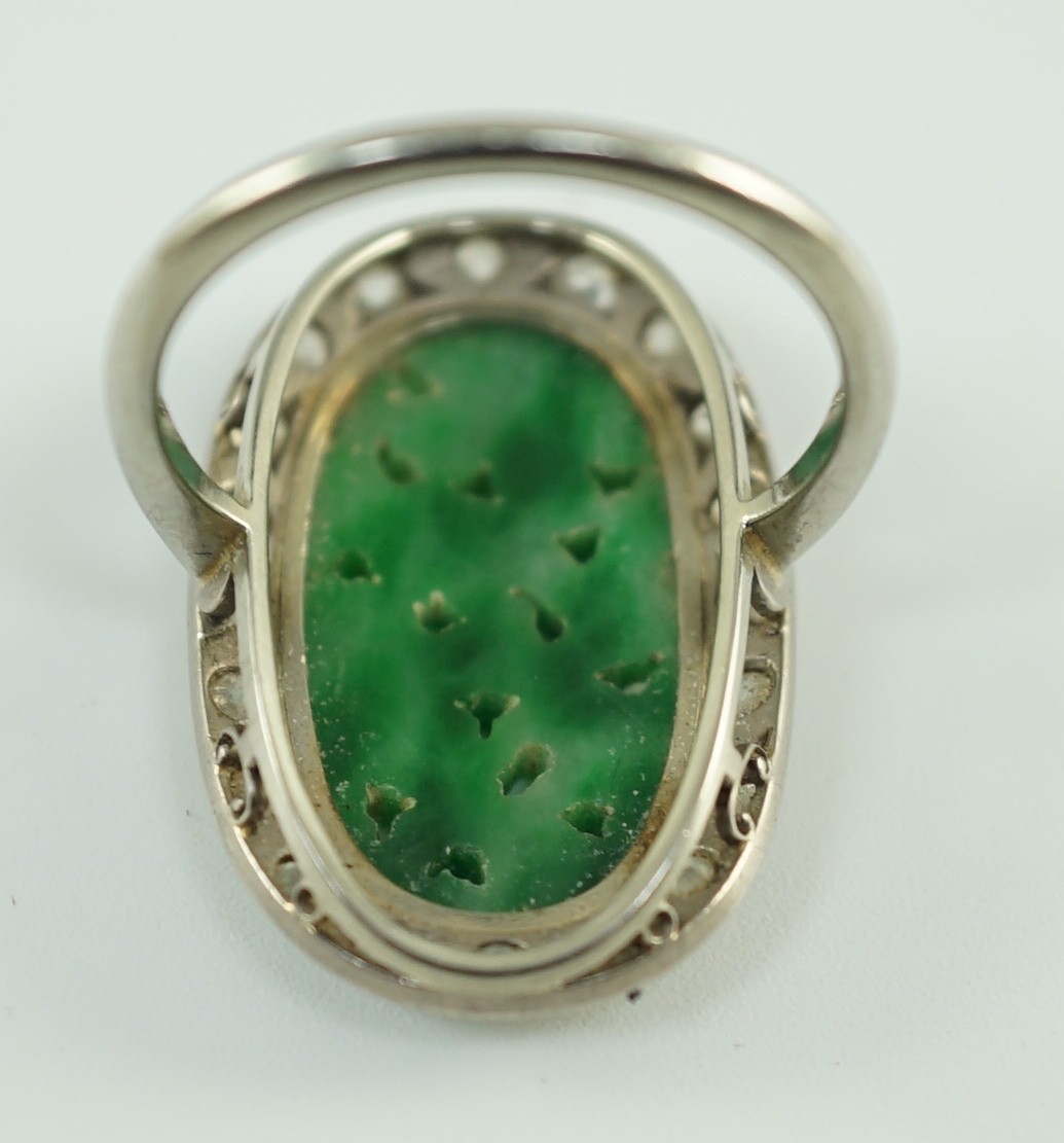 A 1920's/1930's white gold, jadeite and diamond set oval dress ring, the foliate carved jadeite, - Image 2 of 4