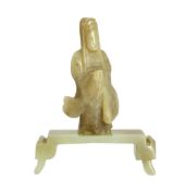 An early Chinese cream jade figure of Guanyin, together with a 19th century pale celadon and brown