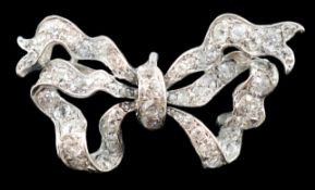 An early to mid 20th century platinum and diamond cluster set ribbon bow pendant brooch, with