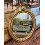 A 19th century French oval giltwood and composition wall mirror, width 80cm, height 119cm.