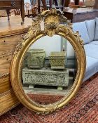 A 19th century French oval giltwood and composition wall mirror, width 80cm, height 119cm.