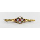 An early 20th century, yellow metal, moonstone, ruby and green garnet cluster set bar brooch,