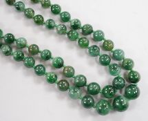 A double strand jade bead necklace, with carved jade and white metal clasp, 45cm, gross weight 101