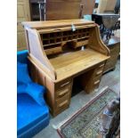 An early 20th century pale oak roll top desk, with 'S' shape tambour, width 121cm, depth 77cm,