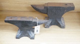 Two cast iron anvils, largest 32cm long and 28lbs