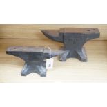 Two cast iron anvils, largest 32cm long and 28lbs