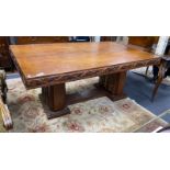 An early 20th century gilt bronze mounted rectangular oak dining table with carved fruiting vine