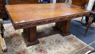 An early 20th century gilt bronze mounted rectangular oak dining table with carved fruiting vine