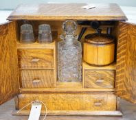 A 1920's oak smoker's / drinks box with decorative interior. 36cm tall, 39cm wide