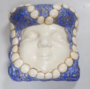 A French Art Deco wall face mask, made by Aladdin Luxe. 14cm tall