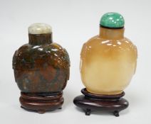 A Chinese honey coloured agate mask and ring handled snuff bottle and a dendritic chalcedony (moss