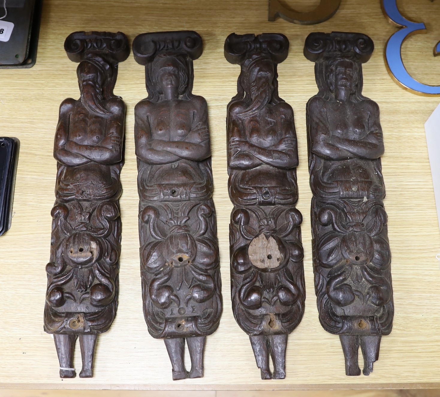 Four early oak figural mounts, possibly Flemish, 16th/17th century, 55cms high