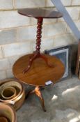 A George III oak tilt top tripod tea table together with a Victorian mahogany bobbin turned tilt top
