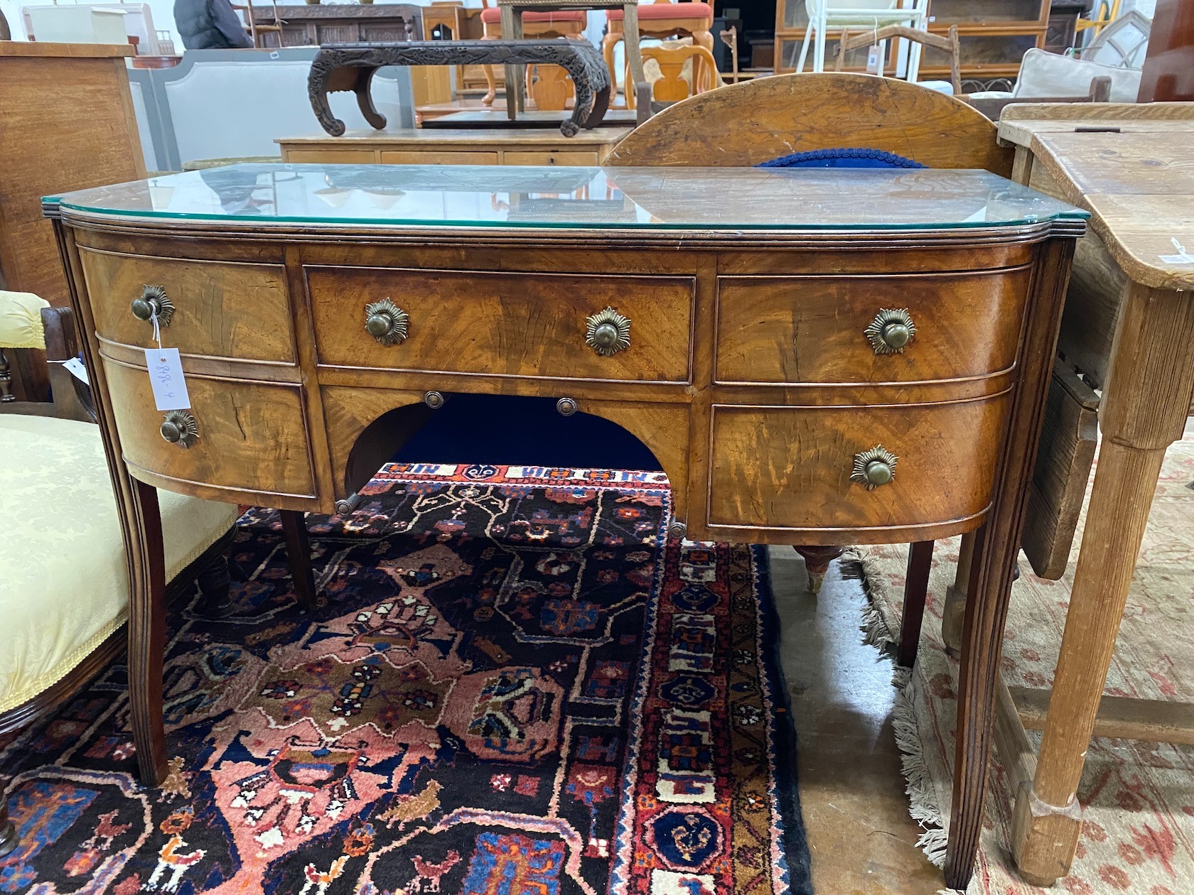 A George III Sheraton period mahogany bow front dressing table, length 112cm, depth 56cm, height