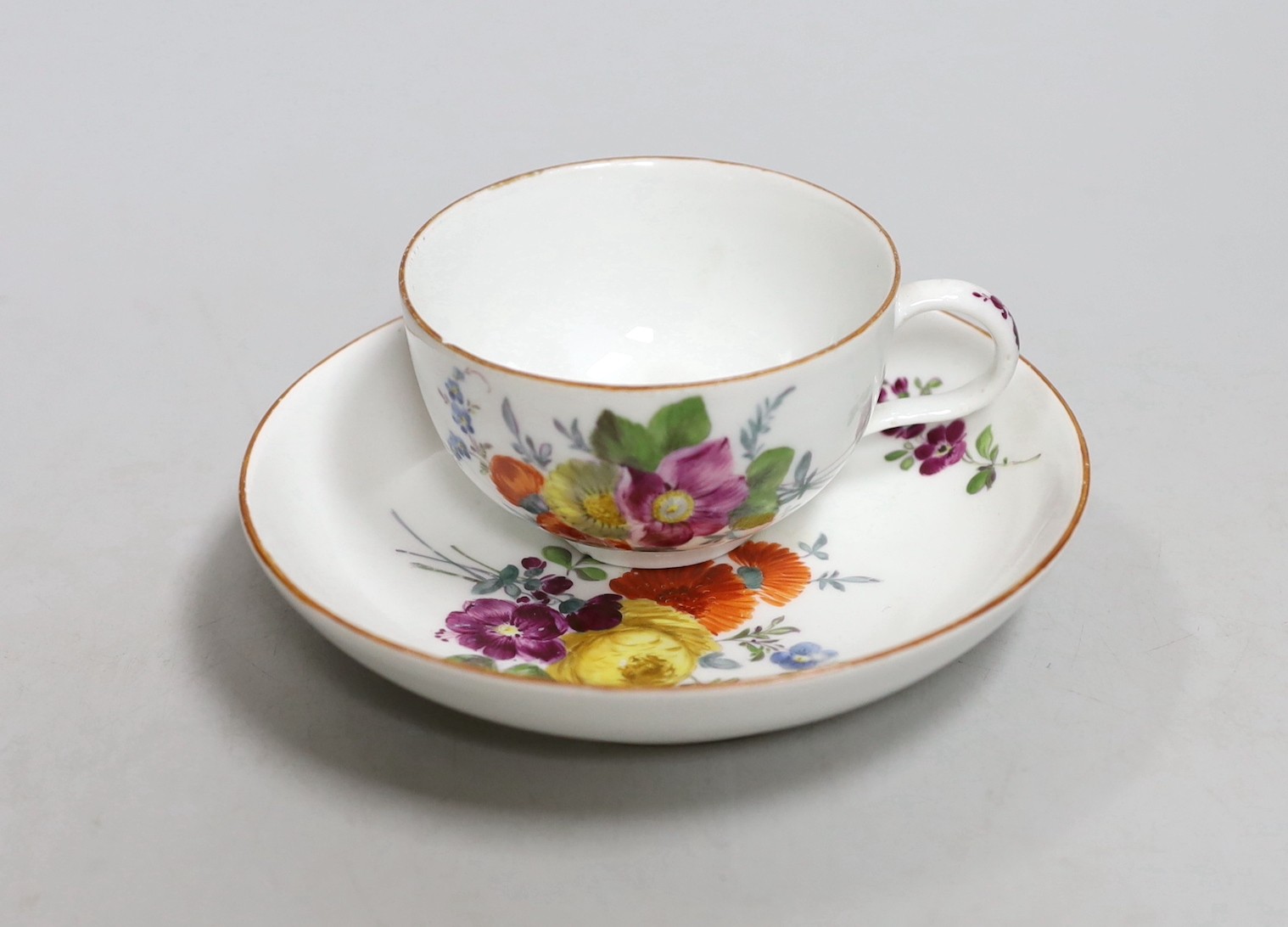 A Meissen dot period flower painted cup and saucer, c.1770