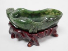 A Chinese spinach green jade 'lotus' brushwasher, 19th century, 6.8cm, wood stand Provenance - the