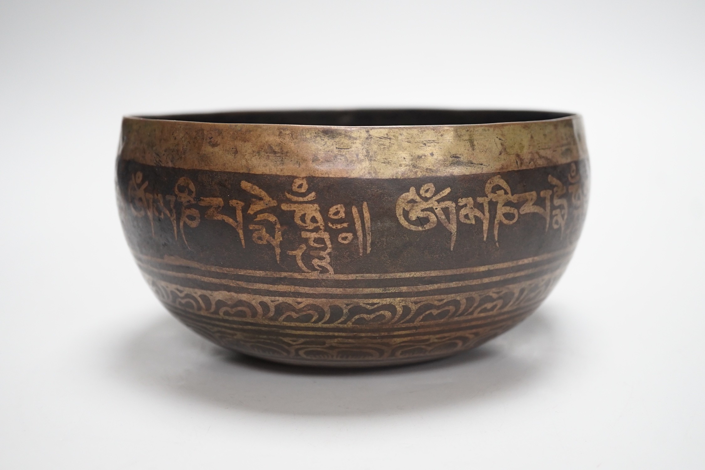 A bronze Nepalese temple bowl decorated with script, 18cm diameter - Image 2 of 5