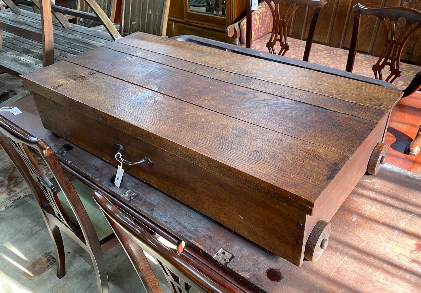 An oak under-bed storage box on wheels, length 123cm, depth 62cm, height 26cm