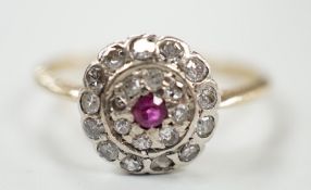An early to mid 20th century, yellow metal ruby and diamond set target cluster ring, size P, gross
