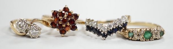 Four assorted modern 9ct gold and gem set rings, including a two stone diamond crossover, size K/