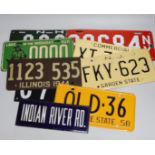 A mixed group of nine USA enamel car registration number plates