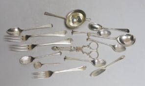 A silver tea strainer and a small collection of assorted 20th century and earlier silver cutlery,