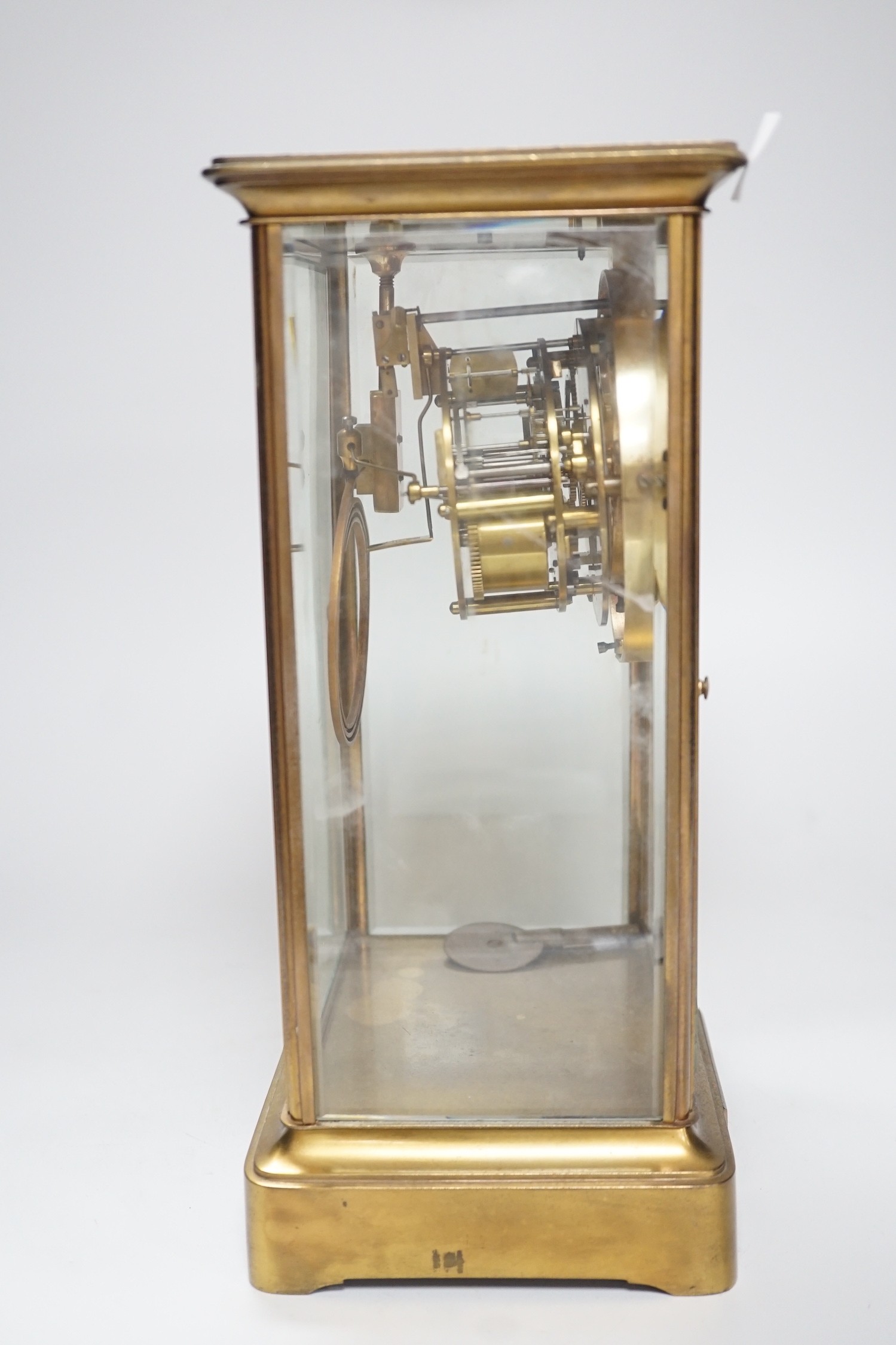 An Edwardian brass four-glass mantel clock with pendulum, presentation plaque to base, 30cm tall - Image 3 of 5