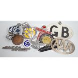 A mixed collection of RAC, AA and other automobile badges.