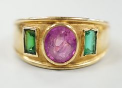 A modern 14k, collet set ruby and green paste? three stone ring, size L, gross weight 4 grams.