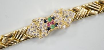 A modern 585 yellow metal, ruby, sapphire, emerald and diamond cluster set bracelet, 17.5cm, gross
