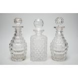 A pair of Victorian cut glass decanters and stoppers and one other, tallest 26cm