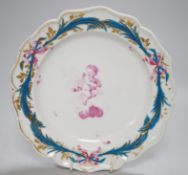 An 18th century Derby plate painted in puce with a cherub on a cloud by Askew. 21cm diameter