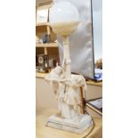 A 1920's carved alabaster clown group figure lamp. 85cm tall