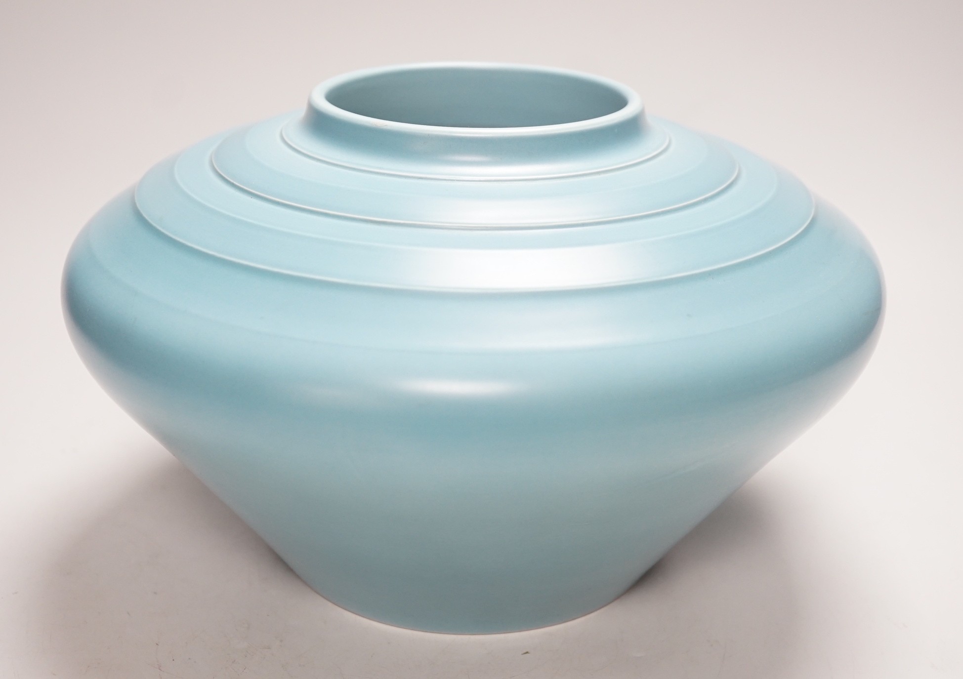 Keith Murray for Wedgwood, a squat vase in blue monochrome glaze, 26cm diameter, 16cm tall