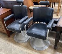 A pair of mid century black leatherette and chrome adjustable barber's chairs, width 62cm