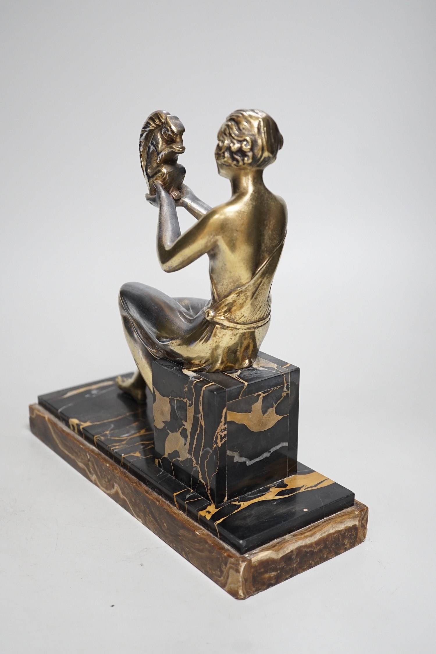 An Art Deco spelter gilded and silvered seated lady holding a squirrel, on marble and onyx mount, - Image 2 of 5