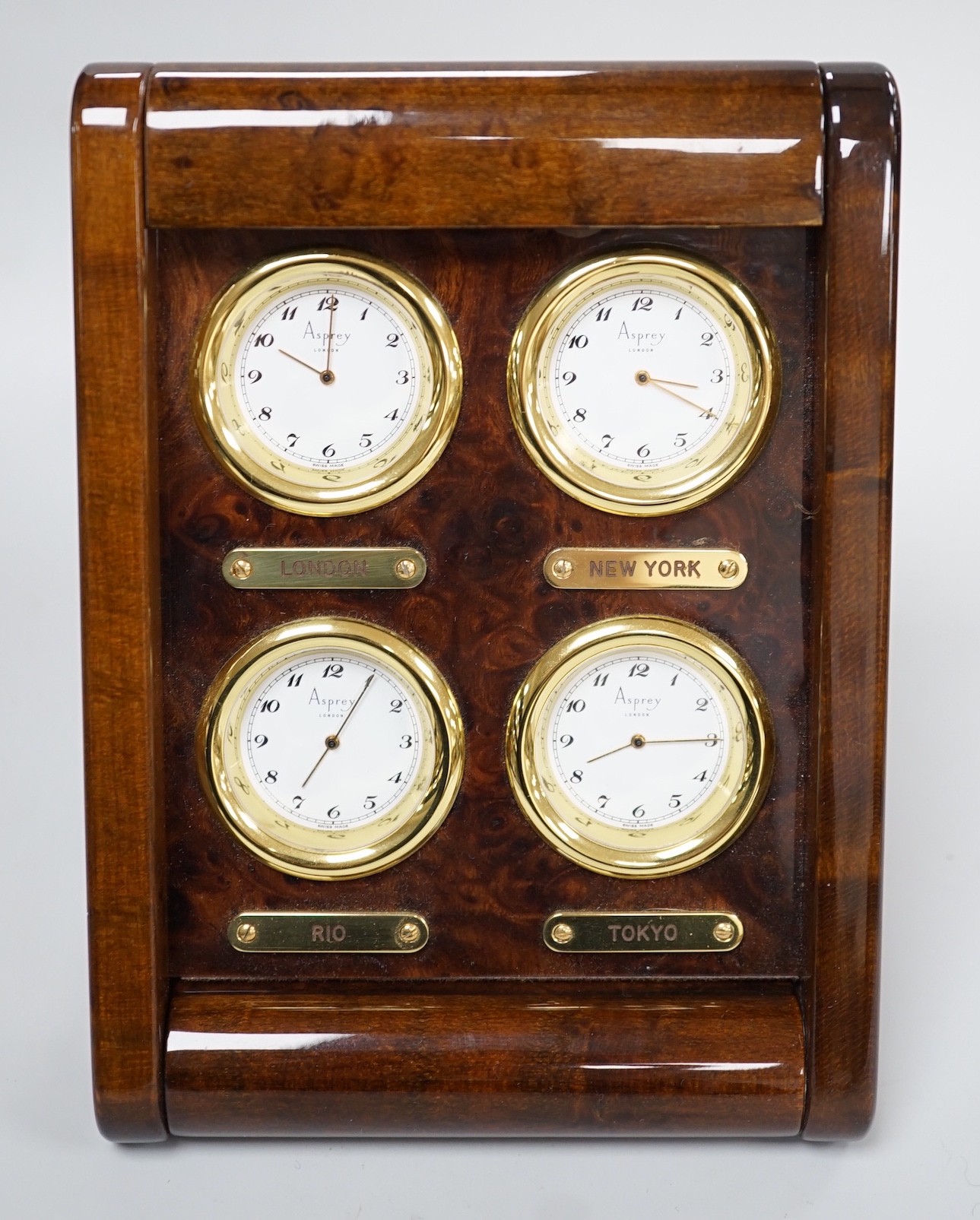 An Asprey burr wood veneered desktop four time zone timepiece, 15.5 cm