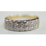 A modern 18ct gold and fourteen stone two row diamond set half hoop ring, size R/S, with textured